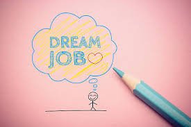 “Hand-drawn illustration of a person thinking about their ‘Dream Job’ inside a colorful thought bubble, with a blue pencil beside it on a pink background.”